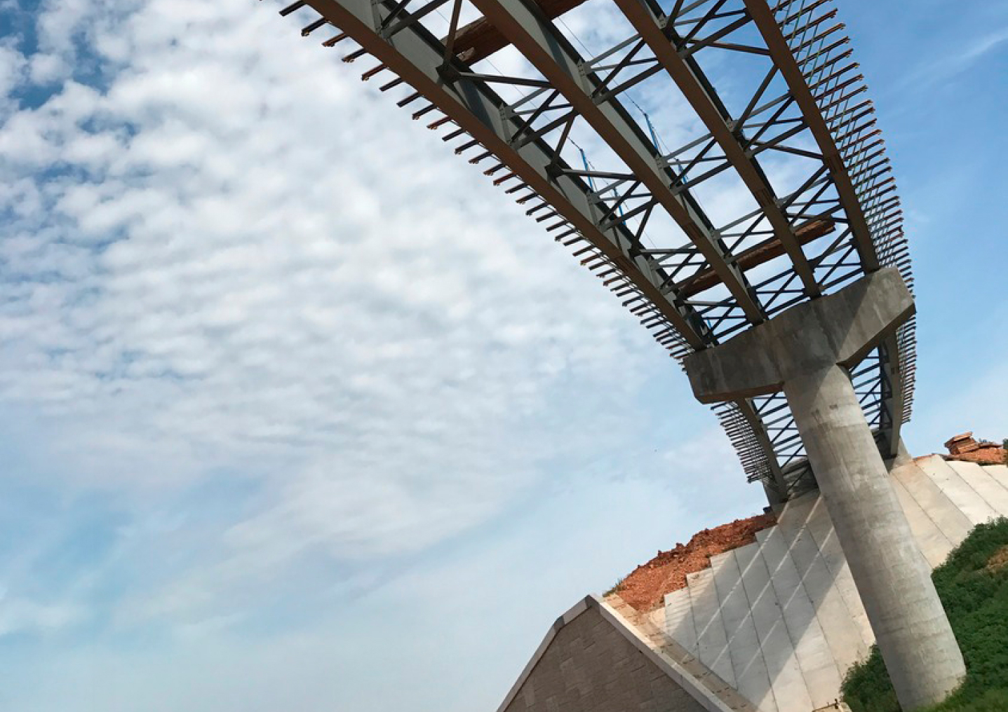 Looking up at a highway overpass partially constructed