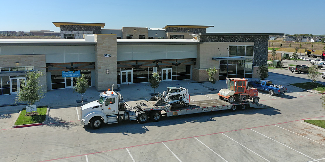 A large truck parked outside of the Three Corners Plaza