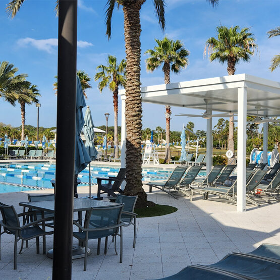 Lawn chairs surrounding a pool