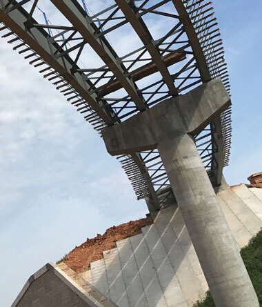 Looking up at a highway overpass partially constructed.