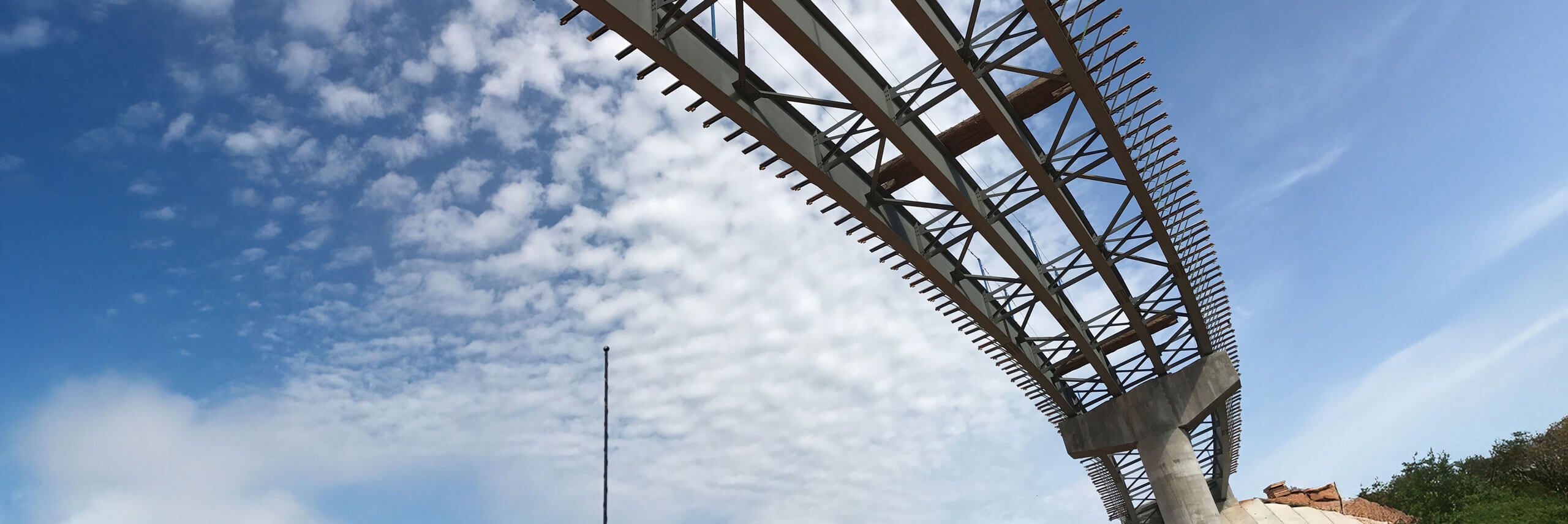 Looking up at a highway overpass partially constructed