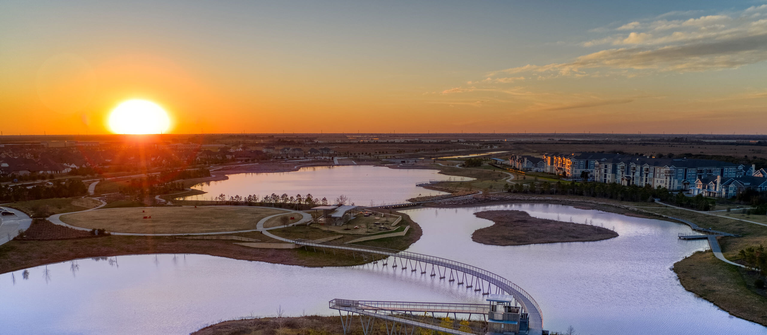 A sunset over a masterplanned community green space.