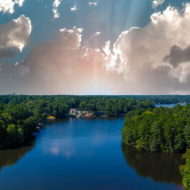 Beautiful trees surrounding crystal blue water in lake in Georgia