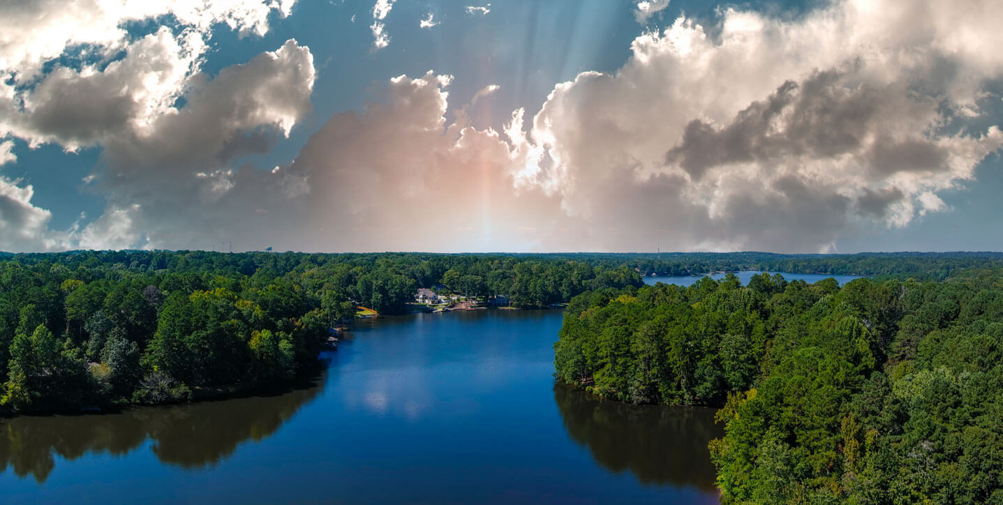 A tree lined, blue water lake in Georgia