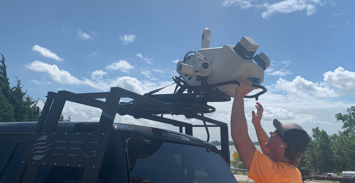 A BGE worker setting LiDar to help with surveying