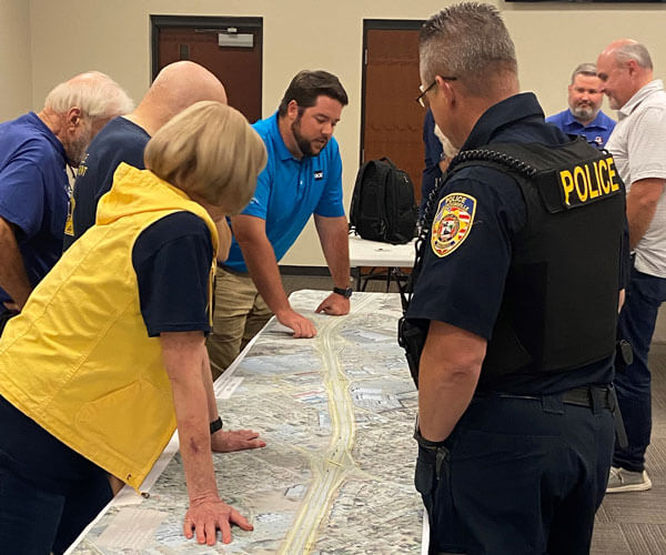 BGE employees looking over highway plans with local police