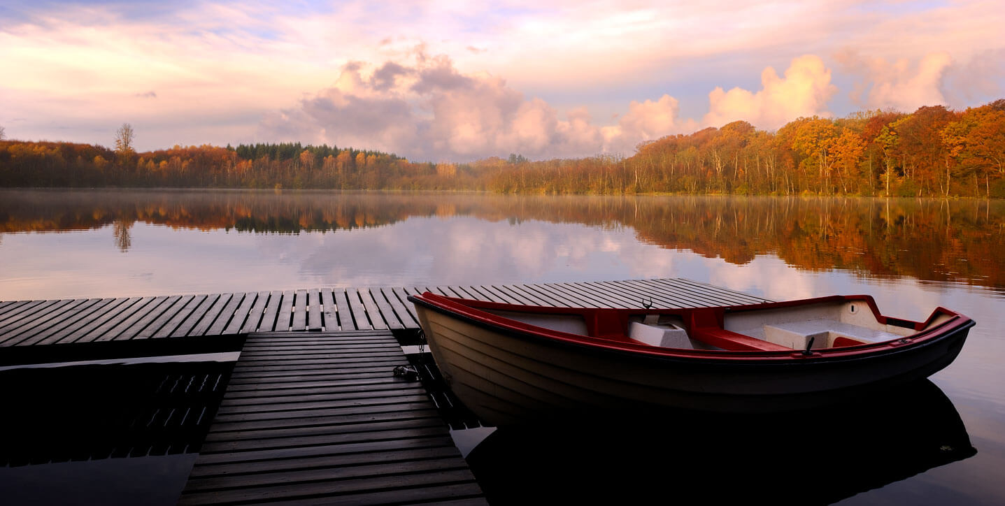 A boat resting by a wooden pier at a lake in Georgia