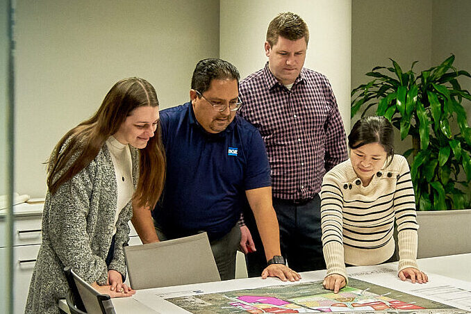 PLA team looks over plans.