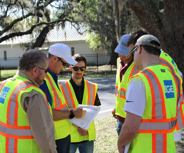 BGE team going over the plan in the field