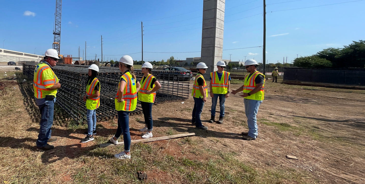 College interns talking to BGE workers at a freeway construction site